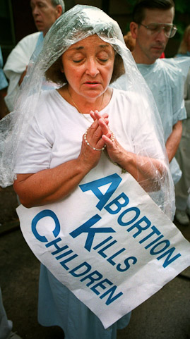 Carolyn Boyle, of Fort Wayne prays the Rosery with agroup of Pro-Life  demonstrators in the park next to the clinic.