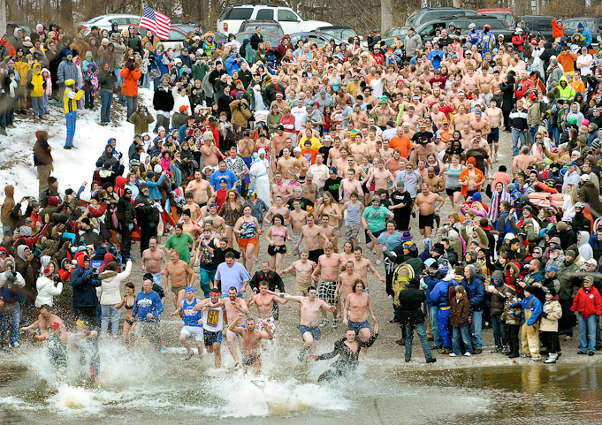 Participants run into the water at the 72nd annual Fort Wayne Polar Bear Club's New Year's Day Polar Bear Plunge Friday afternoon at  Johnny Appleseed Park boat ramp.