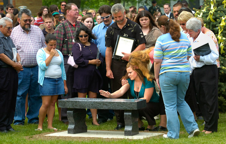 Lindsay GramesSanchez, kneeling at center, is comforted by Vickie Blair, the  mother of CPL. Jonathan Blair, as Lindsay GramesSanchez uses her hand to  transfer a kiss to the bench being dedicated at Elmerst High School for her  late husband Lance Corporal David GramesSanchez and CPL. Jonathan Blair, who  were both killed in Iraq.