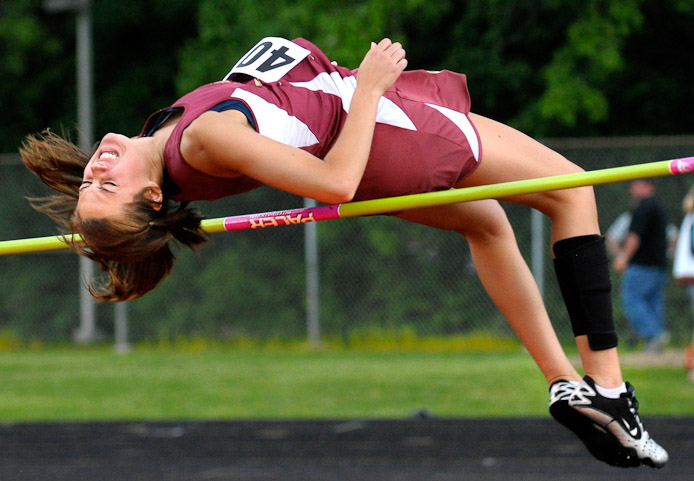 Columbia City's Kinsey Kauffman grimaces as she brusses the bar to finish third in the high jump at 5' 3.5