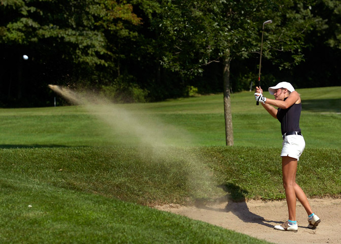 Snider High School senior Alex Riley hits out of the sand against Homestead during the first girl's golf match of the season.