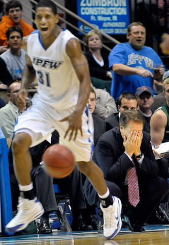 Michigan State Head Coach Tom Izzo, lower right, covers his face not believing what he is seeing as a smiling Deilvez Yearby, left, brings the ball up the court for IPFW, with the mastodons leading 44-42 with just under 11 minutes left in the second half against #5 Michigan State at memorial Coliseum Wednesday night. IPFW fell short 70-59.