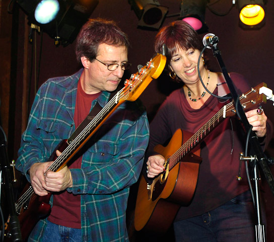 Bass player Rob Suraci, left, and Rhythm guitarist Susie Suraci, right, get  tuned-up before playing with the Possum Trot Orchestra,  at Columbia Street  West.
